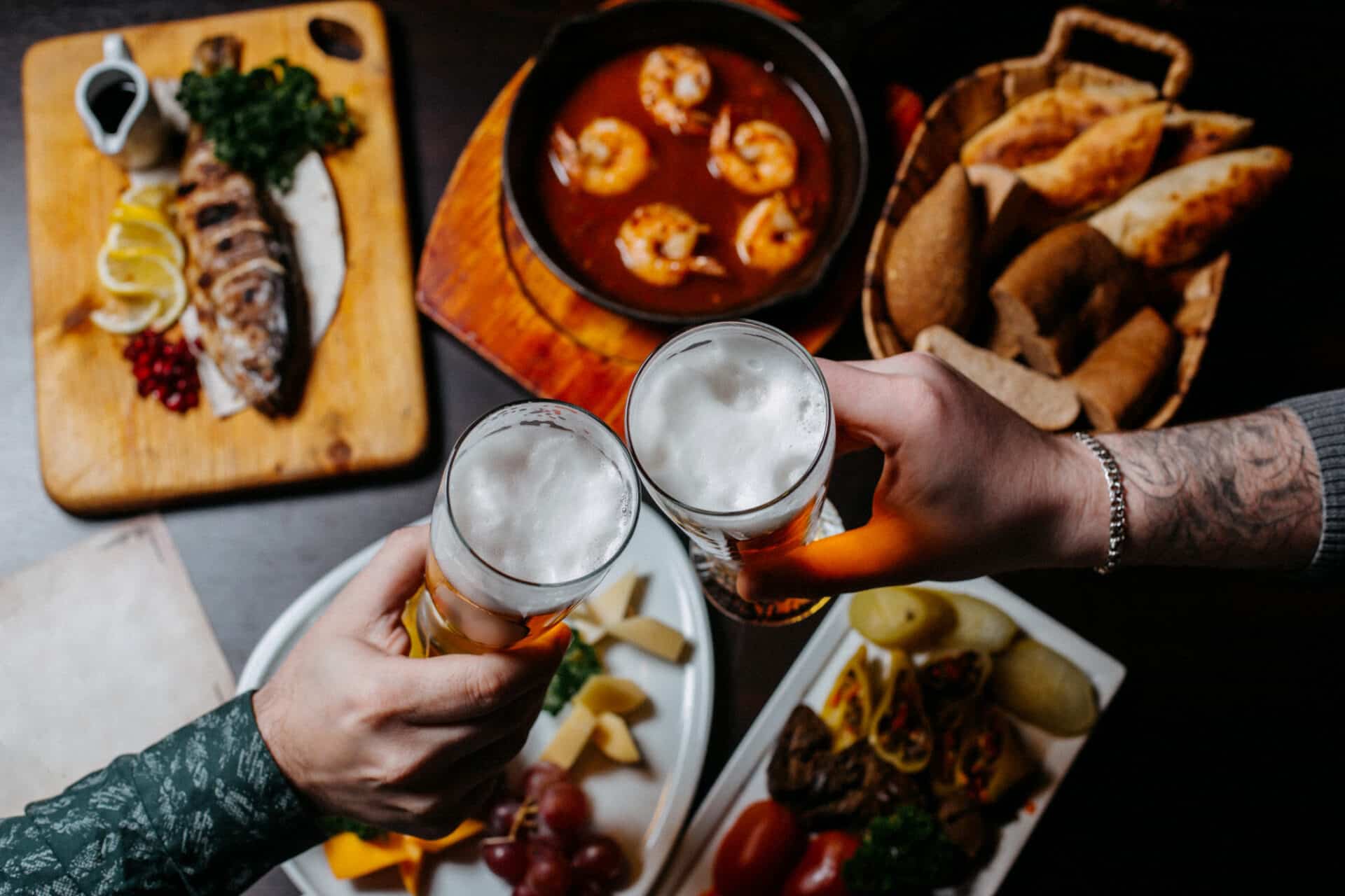 top view hands holding beer glasses pub surface