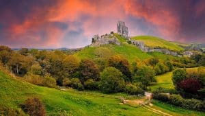 Photo of Corfe Castle amid lush Dorset countryside