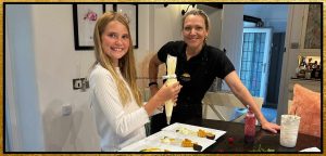 photo of Laura in her kitchen with a young guest