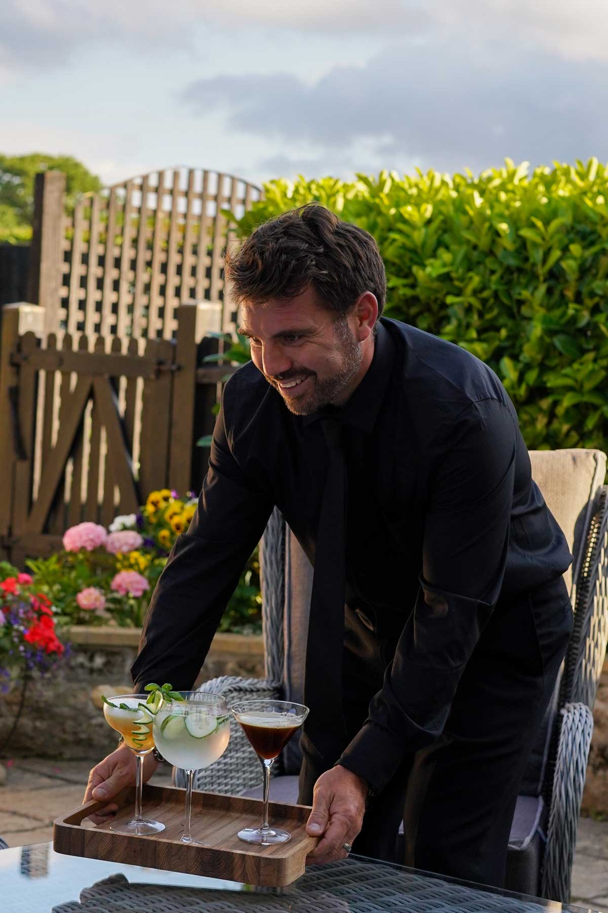 Nathan serving cocktails on the lawn