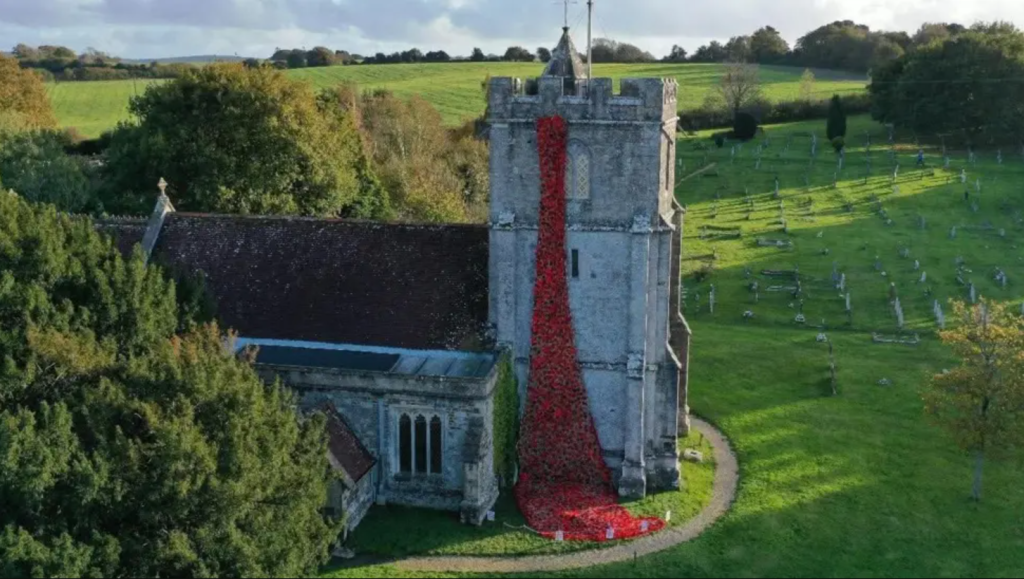 photo of knitted Remembrance poppies hung from Holy Rood Church in Wool Dorset photo of knitted Remembrance poppies hung from Holy Rood Church in Wool Dorset