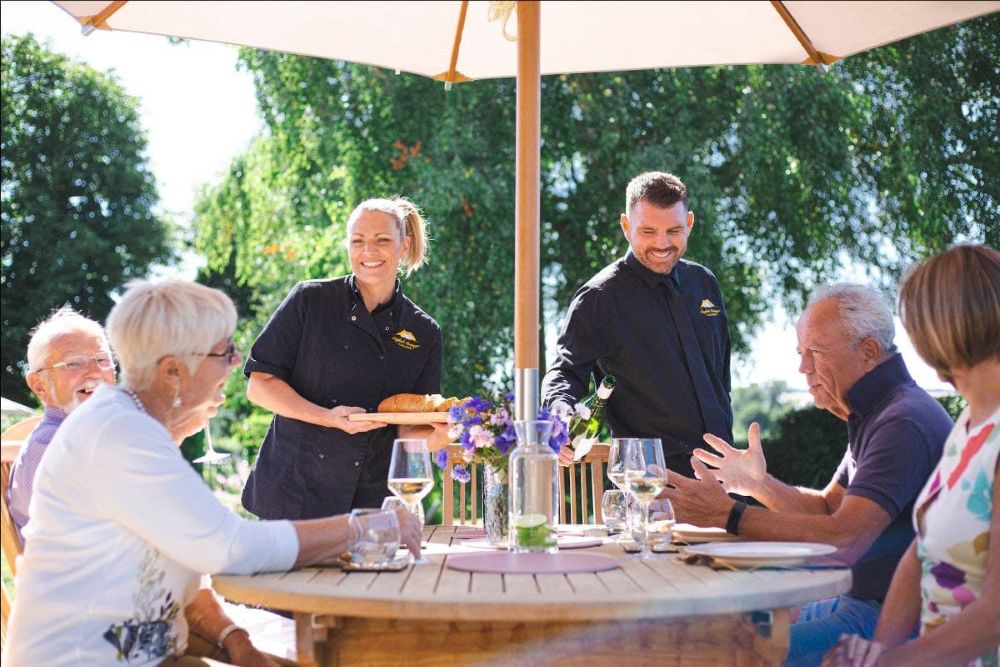 Laura-and-Nathan-serving-guests-outdoors
