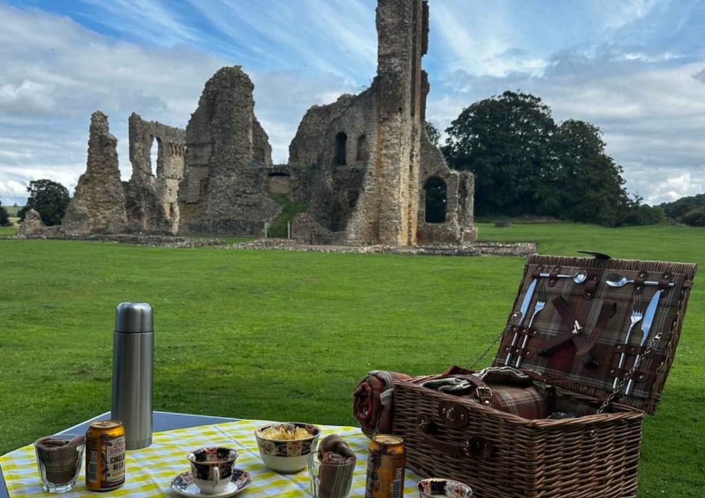 photo of picnic set-up in front of castle ruins photo of picnic set-up in front of castle ruins