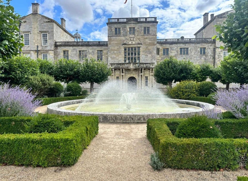 photo of Wilton House and gardens featuring a water fountain and lavender